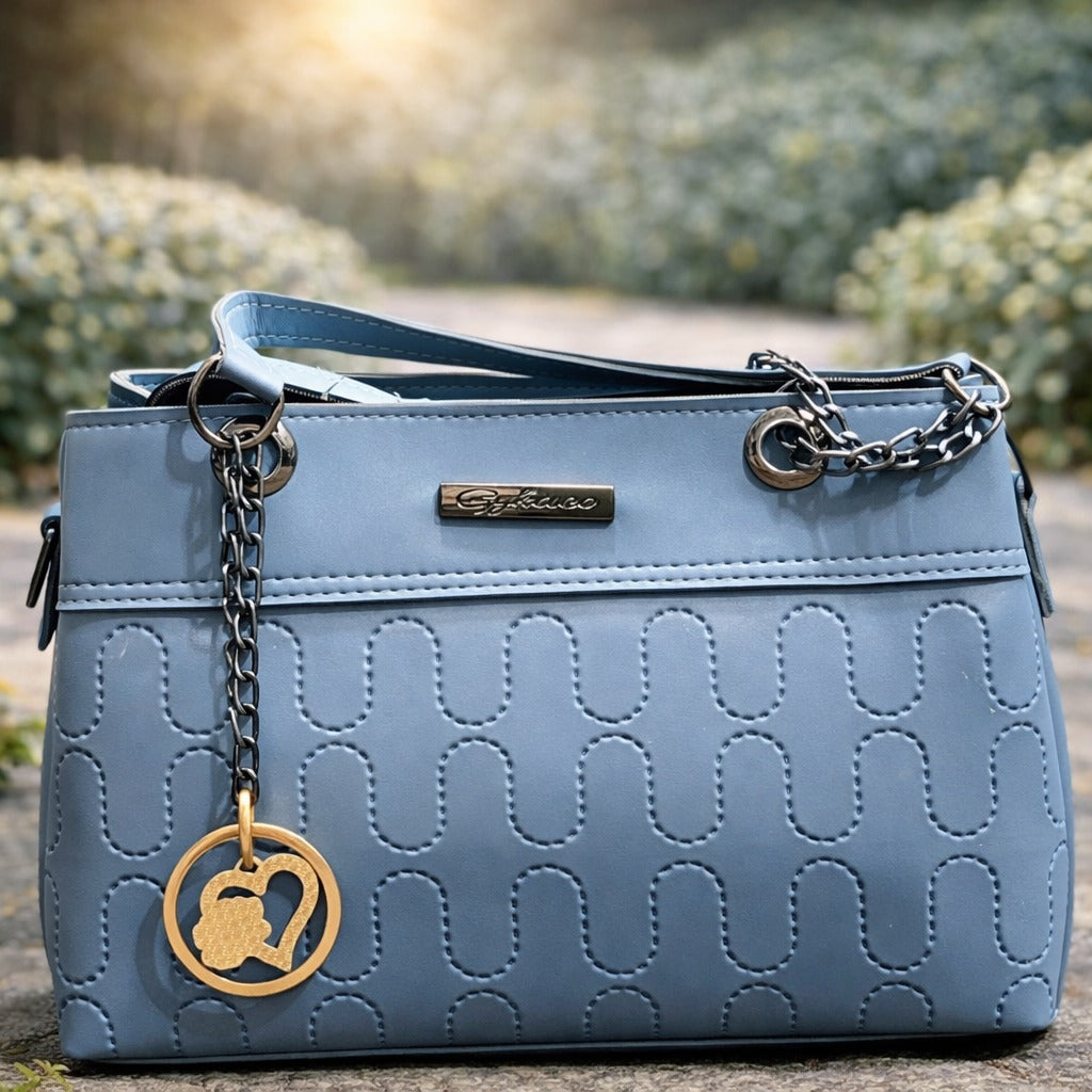 Blue handbag with a gold charm | WearCareHub